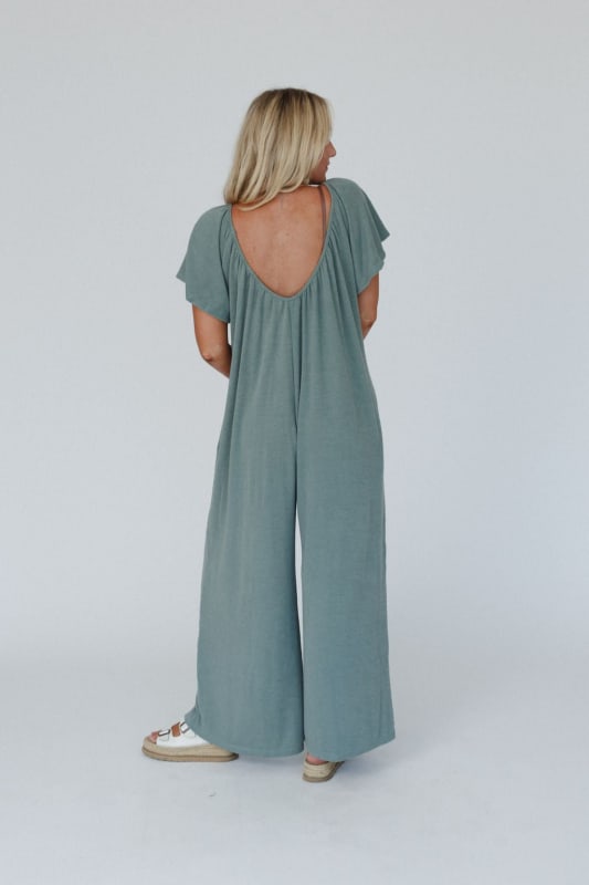 back view of The Nest Calista Jumpsuit in Sage from Three Bird Nest