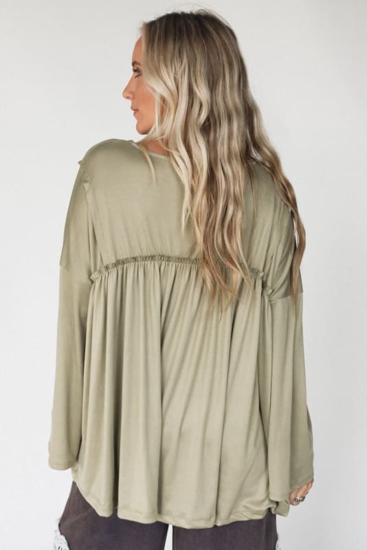 back view of The Nest Solid Serenity Long Sleeve Babydoll Top in Olive from Three Bird Nest